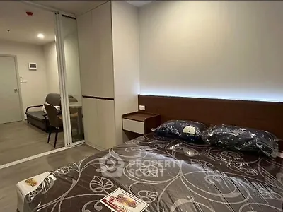 Modern bedroom with stylish decor and sliding glass doors leading to a cozy living area.