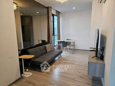 Modern living room with sleek design, featuring a comfortable sofa, wall-mounted TV, and dining area with city view.