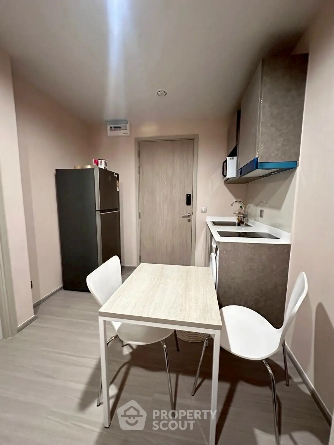 Modern compact kitchen with dining area and sleek appliances