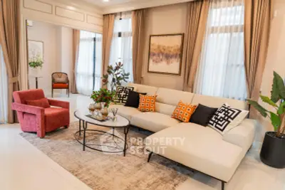 Luxurious living room with elegant decor, featuring a stylish sofa, chic armchair, and modern artwork.