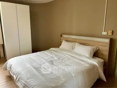 Cozy bedroom with modern wooden bed and sleek white wardrobe, perfect for restful nights.