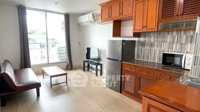 Spacious living room with modern kitchen and large window view