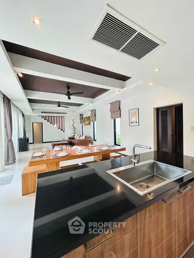 Luxurious open-plan kitchen and dining area with modern fixtures and elegant design.