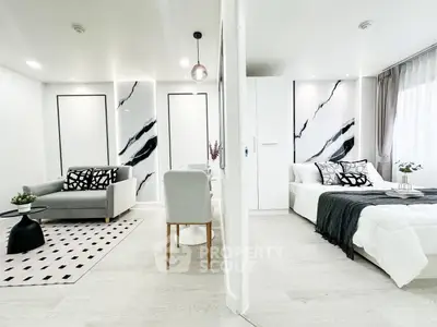 Modern open-plan living room and bedroom with stylish decor and natural light