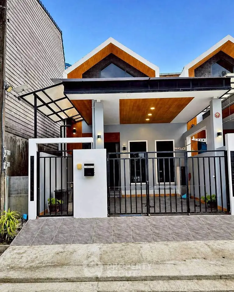 Modern townhouse exterior with sleek design and gated entrance, perfect for urban living.