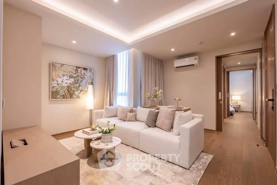 Elegant living room with modern decor, cozy white sofa, and ambient lighting in a stylish apartment.
