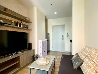 Cozy living room with modern decor and entertainment center in a stylish apartment.