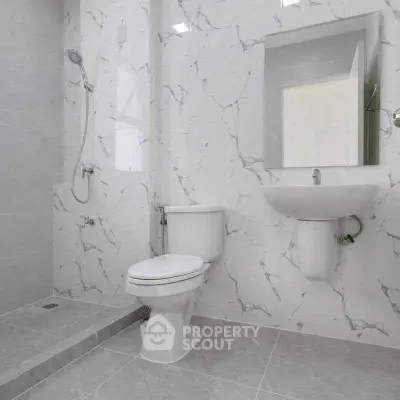 Modern bathroom with marble tiles and sleek fixtures in a contemporary home.