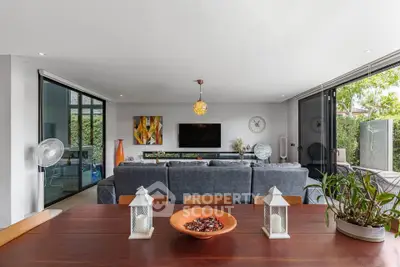 Spacious modern living room with open layout and stylish decor, featuring large windows and abundant natural light.