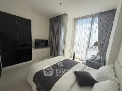 Modern bedroom with large windows and stylish decor in a high-rise apartment.