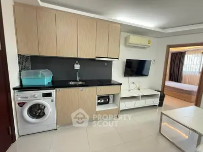 Modern kitchen with washing machine and open layout in stylish apartment