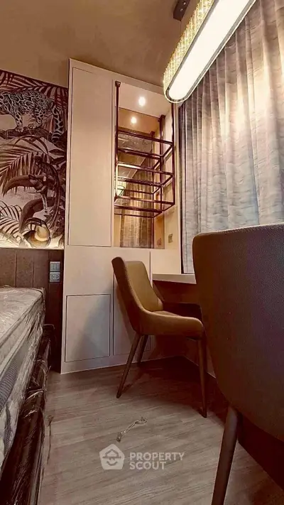 Stylish bedroom with modern decor and cozy seating area, perfect for relaxation and comfort.