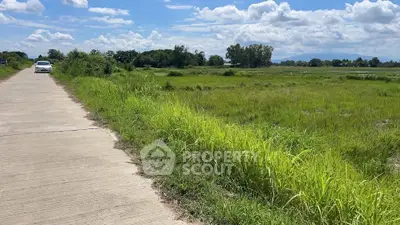 Expansive green land with clear skies, perfect for development opportunities.