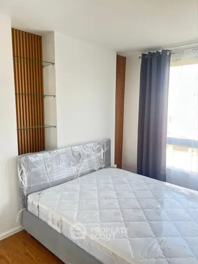 Modern bedroom with stylish decor and large window for natural light