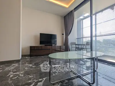 Modern living room with marble flooring and large windows opening to a balcony.