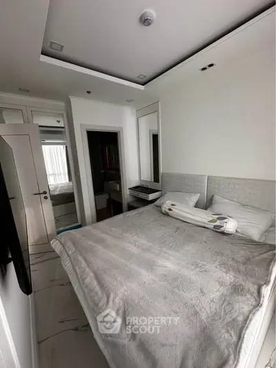 Cozy modern bedroom with sleek design and ample natural light