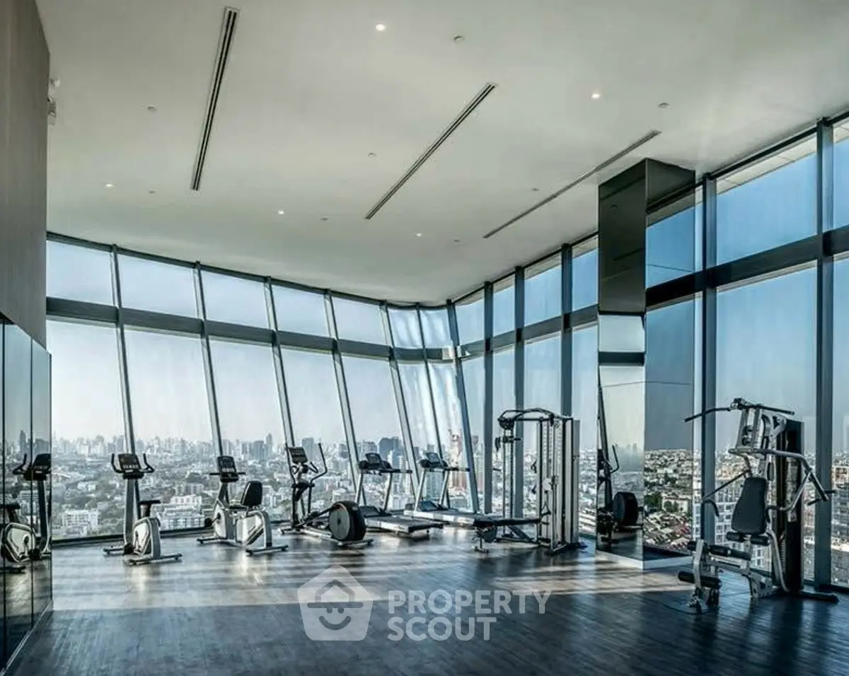 Luxurious high-rise gym with panoramic city views and modern fitness equipment.