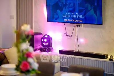 Modern living room with TV and stylish decor, perfect for entertainment.