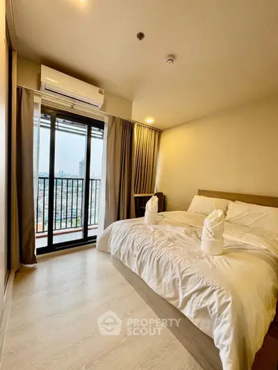 Spacious bedroom with balcony and city view in modern apartment