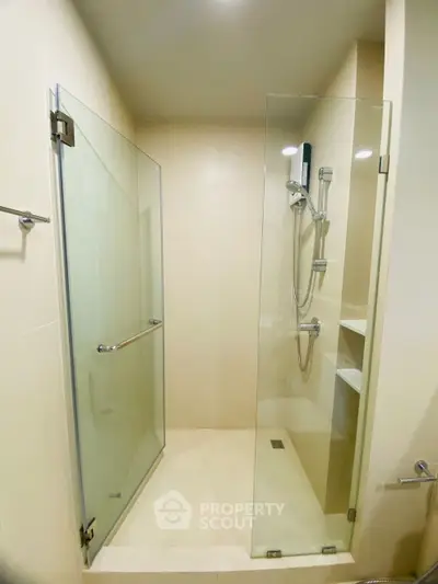 Modern bathroom with glass shower enclosure and sleek fixtures