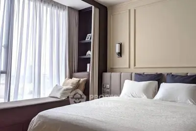 Elegant bedroom with large window and cozy seating area, featuring modern decor and soft lighting.