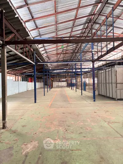 Spacious industrial warehouse with high ceilings and ample storage potential.