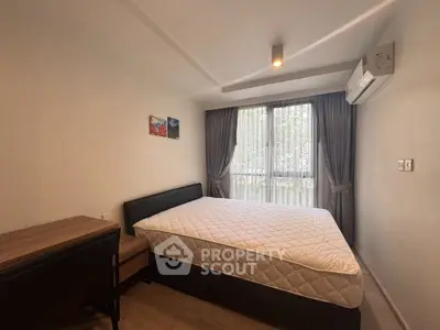 Modern bedroom with large window and air conditioning in a stylish apartment.