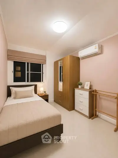 Cozy bedroom with modern furnishings and air conditioning, perfect for a comfortable living experience.