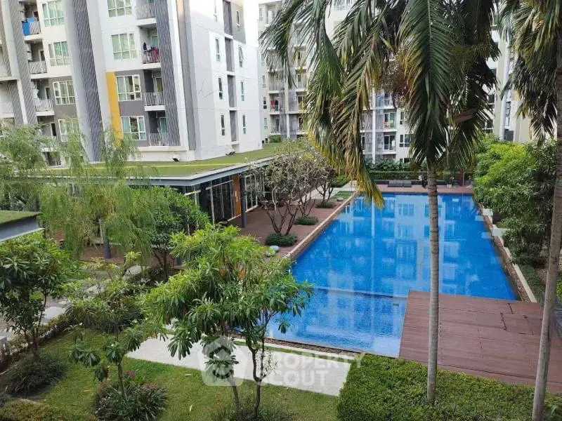 Luxurious residential complex with a stunning pool and lush greenery, perfect for relaxation and leisure.