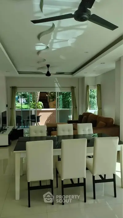 Spacious modern living room with dining area and large windows