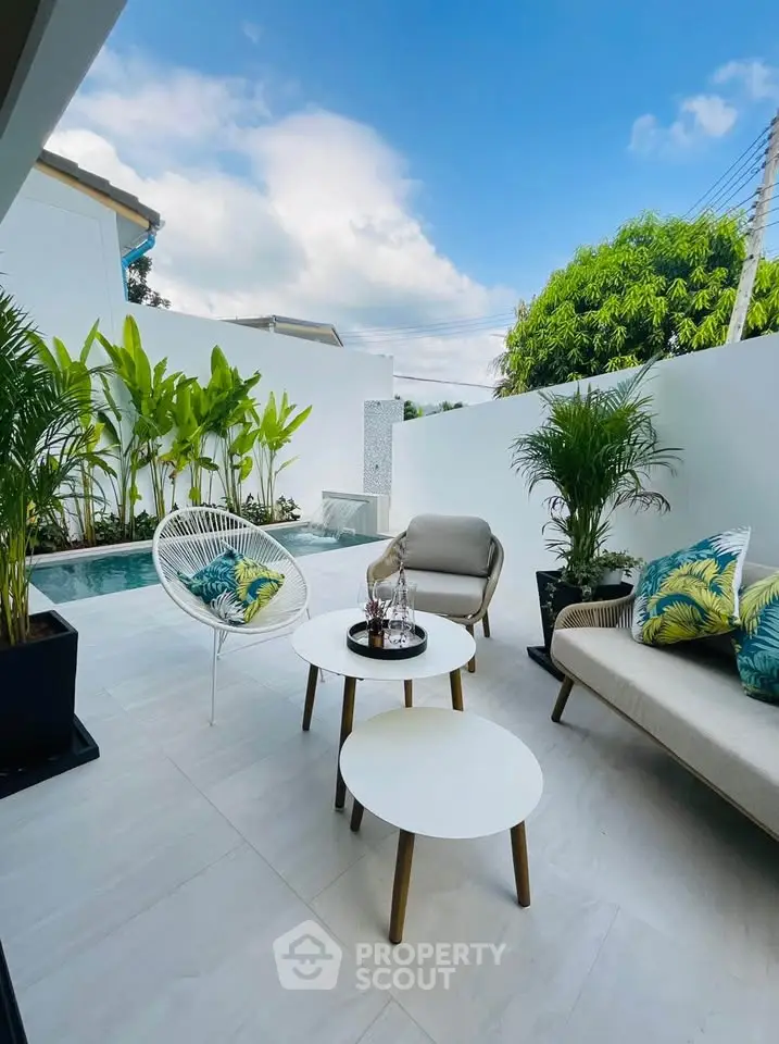 Chic outdoor patio with modern furniture and lush greenery, perfect for relaxation and entertaining.