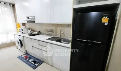 Modern kitchen with sleek appliances and ample storage space.