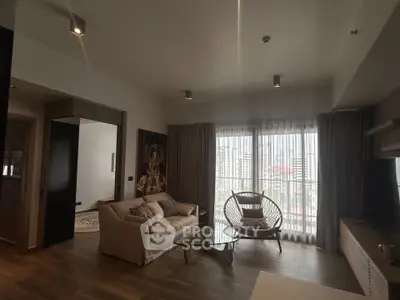 Modern living room with city view, cozy seating, and stylish decor