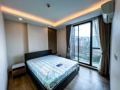 Modern bedroom with balcony view in urban apartment