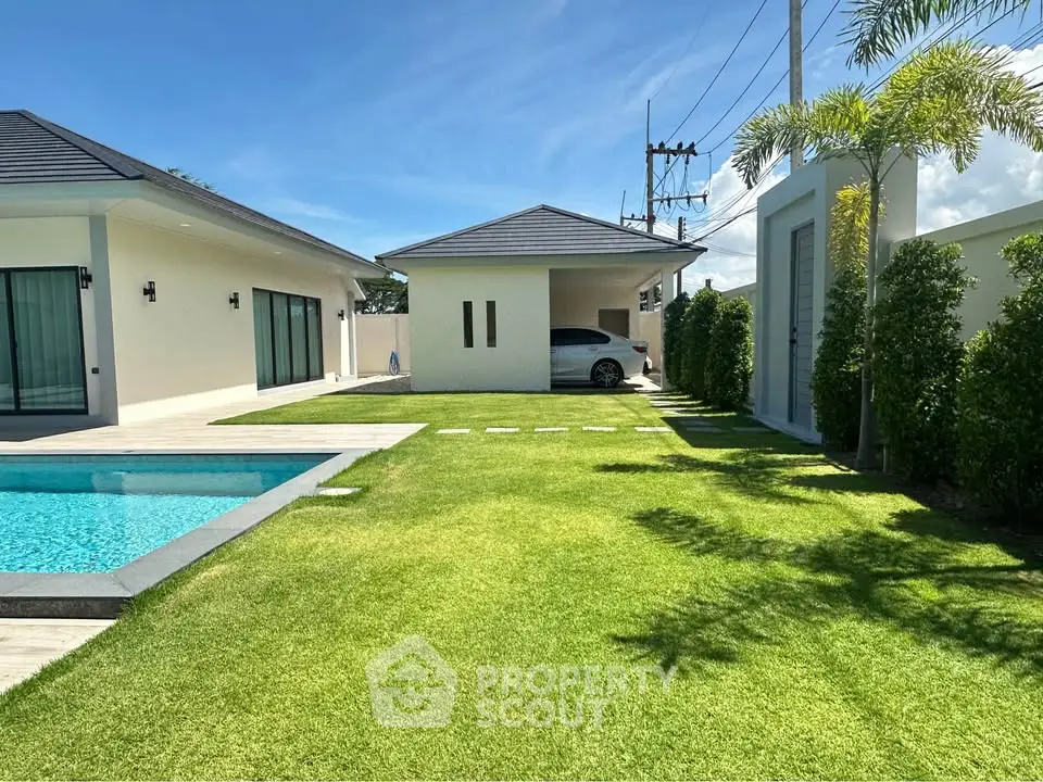 Luxurious modern villa with pool and lush garden, perfect for relaxation and entertaining.