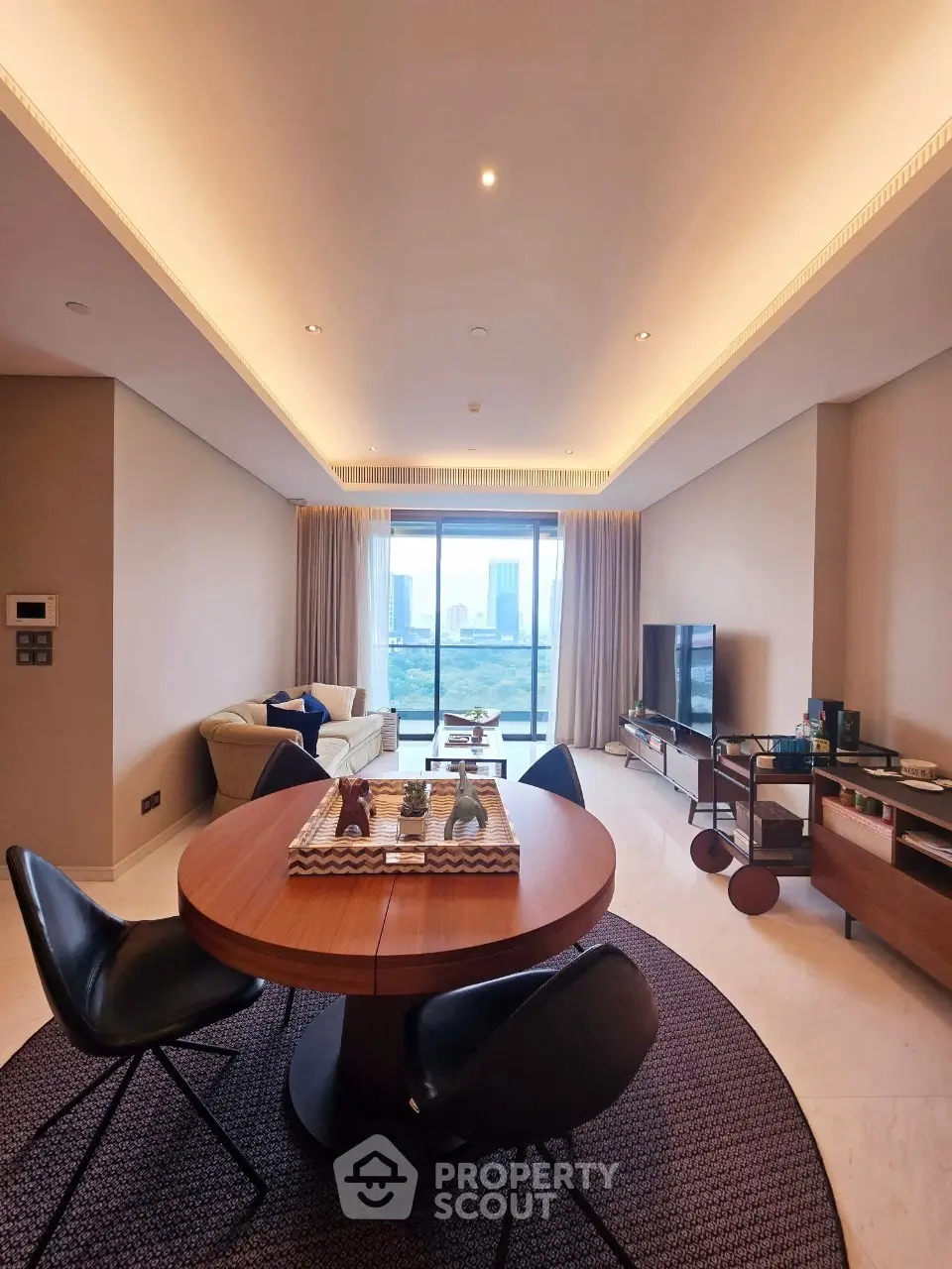 Luxurious living room with modern furniture and stunning city view through large windows.