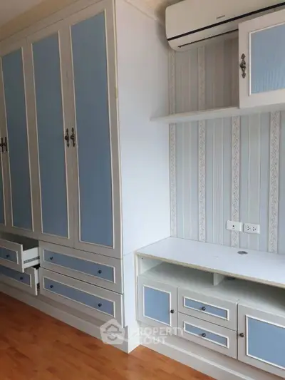 Stylish bedroom with built-in wardrobe and air conditioning unit