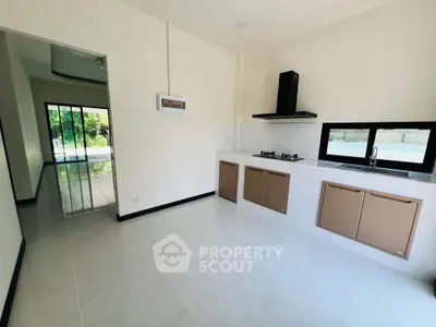 Modern kitchen with sleek cabinetry and gas stove in a bright, open layout home.
