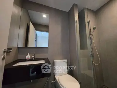 Modern bathroom with sleek fixtures and glass shower enclosure