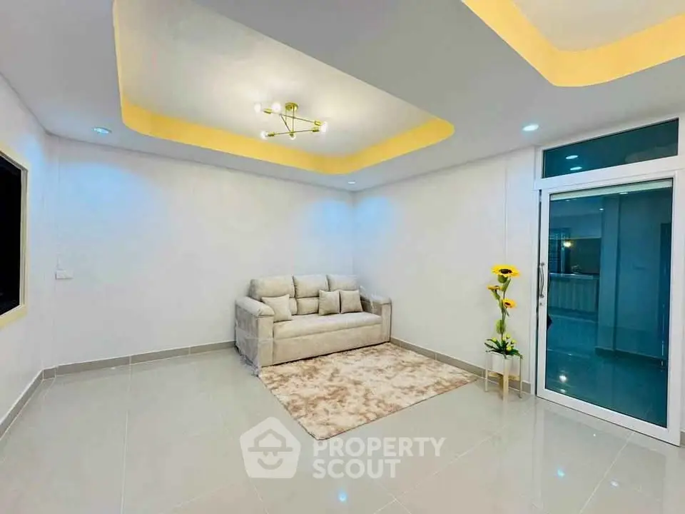 Modern living room with elegant lighting and cozy sofa in a spacious interior.