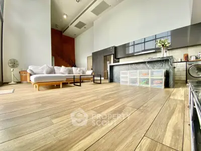 Spacious modern living room with open kitchen and high ceilings