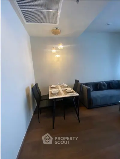 Modern dining area with elegant table setting and cozy seating in a stylish apartment.