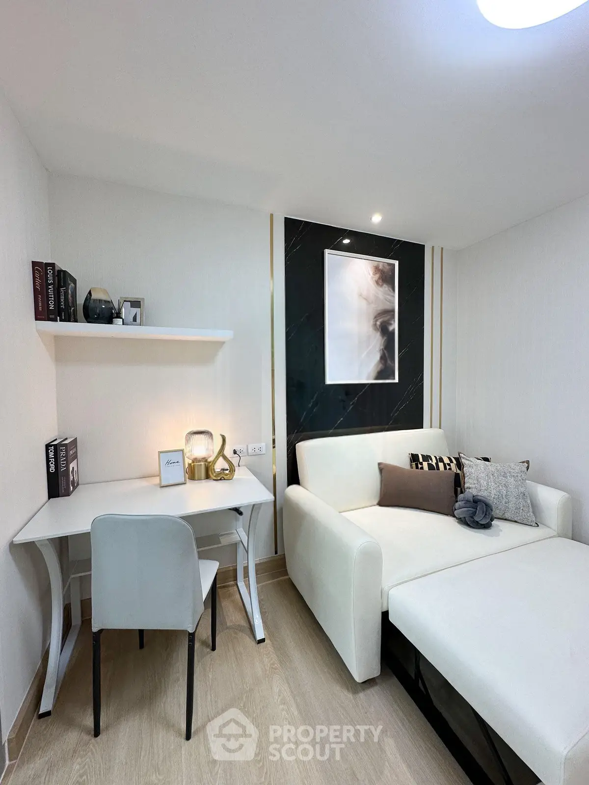 Modern living room with stylish decor and cozy seating area, perfect for relaxation and work-from-home setup.