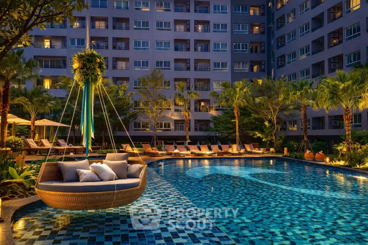 Luxurious apartment complex with stunning pool and lush landscaping at twilight.