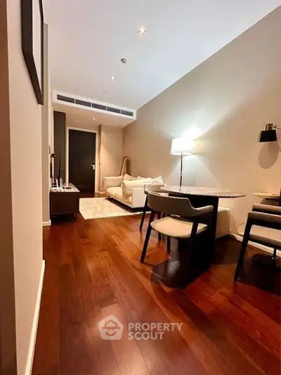 Elegant living room with hardwood floors and modern furniture in a stylish apartment.