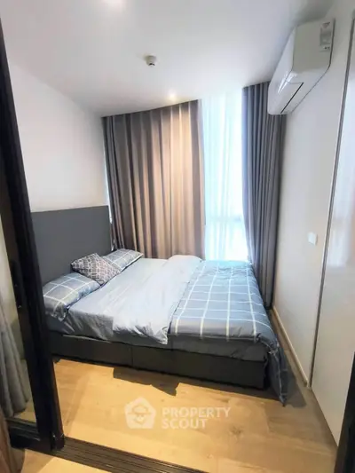 Cozy bedroom with modern decor and natural light, featuring a comfortable bed and stylish curtains.