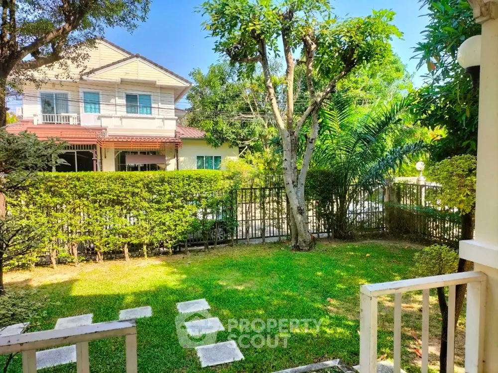 Charming garden view from a cozy home with lush greenery and serene ambiance.