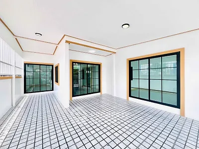 Spacious modern balcony with large windows and tiled flooring
