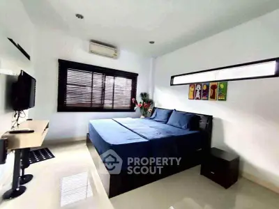 Spacious modern bedroom with sleek design and natural light