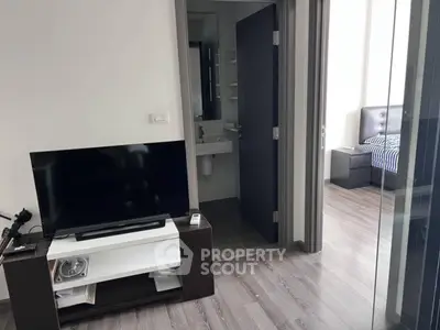 Modern apartment interior with TV, bathroom, and bedroom view